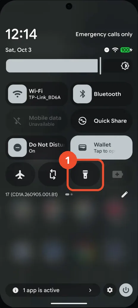 Swipe down twice to open Quick Settings and find the Flashlight tile